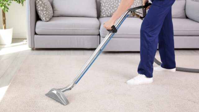 vacuuming living room carpet
